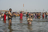 Kumbh Mela 2025: The Sacred Goes Viral. Capturing the Sacred Moment. Pilgrims Taking a Selfie During the Sacred Bath. A group of pilgrims, united by their faith, take a moment to capture a selfie during the sacred bath at the Kumbh Mela. With the holy waters of the Ganges flowing around them, they smile and pose for the camera, immortalizing the experience on their smartphones. This image beautifully juxtaposes the timeless spiritual significance of the bath with the contemporary desire to document the moment. The scene highlights how the younger generation engages with ancient traditions through the lens of modern technology, while still embracing the deeply rooted rituals that have defined the Kumbh Mela for centuries. The selfie becomes a bridge between personal memories and the collective spiritual journey of millions.