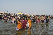 Kumbh Mela 2025: The Sacred Goes Viral. Capturing the Sacred Moment. Pilgrims Taking a Selfie During the Sacred Bath. A group of pilgrims, united by their faith, take a moment to capture a selfie during the sacred bath at the Kumbh Mela. With the holy waters of the Ganges flowing around them, they smile and pose for the camera, immortalizing the experience on their smartphones. This image beautifully juxtaposes the timeless spiritual significance of the bath with the contemporary desire to document the moment. The scene highlights how the younger generation engages with ancient traditions through the lens of modern technology, while still embracing the deeply rooted rituals that have defined the Kumbh Mela for centuries. The selfie becomes a bridge between personal memories and the collective spiritual journey of millions.