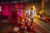 Kumbh Mela 2025: The Sacred Goes Viral. A Young Sadhu in the Heart of the Kumbh Mela. A Child Sadhu at the Kumbh Mela: The Innocence of Devotion. In a dimly lit tent filled with spiritual energy, a young sadhu sits serenely, raising his hand in blessing. Dressed in bright orange, his innocent face is adorned with necklaces and surrounded by a sense of purity and devotion. A group of adult devotees stands in the background, with one woman holding offerings while others look on. The tent glows warmly with decorative lights, creating a contrast between the child’s spiritual purity and the bustling activity of the Kumbh Mela around him. This scene encapsulates the timeless nature of devotion, where even the youngest participants contribute to the sacred atmosphere of the event.