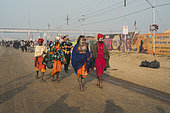 Kumbh Mela 2025: The Sacred Goes Viral. The Walk of the Sadhus. Spiritual Seekers at the Heart of the Kumbh Mela. The sadhus, revered ascetics of Hinduism, are among the most striking figures at the Maha Kumbh Mela. Draped in vibrant robes, adorned with sacred ash, and carrying only the bare essentials, they walk through the vast pilgrimage grounds, embodying renunciation and devotion. Their presence is a reminder of the spiritual essence of the festival, where seekers abandon worldly comforts in pursuit of enlightenment. As they move through the crowds, their journey symbolizes the timeless tradition of asceticism, deeply woven into the fabric of the Kumbh Mela.