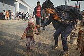 Kumbh Mela 2025: The Sacred Goes Viral. Faith and Reality. Beyond the Rituals: Life on the Margins of the Kumbh Mela. While millions of pilgrims come to the Maha Kumbh Mela seeking spiritual purification, life on the riverbanks tells another story. Amidst the grand rituals and sacred waters, families build temporary shelters, and children navigate the daily realities of survival. This image captures the contrast between faith and hardship, showing that while the Kumbh Mela is a place of devotion, it is also a space where resilience, community, and the struggle for a better life unfold side by side.