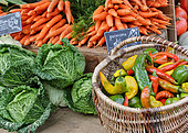 Selling vegetables at the market. Carrots, cabbages and peppers at the Jacobins market, Le Mans, Sarthe, France