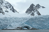 Glacier front and natural arch in foreground in Spitsbergen, Svalbard Archipelago