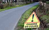 "Hunting in progress" sign by a country road, Sarthe, France