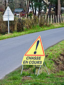 "Hunting in progress" sign by a country road, Sarthe, France