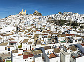 The hilltop White Town of Olvera with its La Encarnación church and Moorish castle. Aerial view. Drone shot. Cádiz province, Andalusia, Spain.