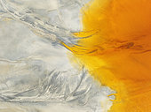 Waste pond in the mineral-rich area of the Rio Tinto mines. The colour is caused by oxidised iron minerals. Aerial view. Drone shot. Huelva province, Andalusia, Spain.
