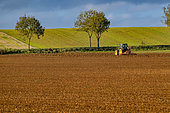 Tractor ploughing in a country landscape, Lorraine, France