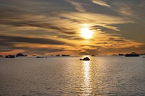 Icebergs and large fragments of drifting ice, here in the light of a summer evening, giant icebergs floating on the southern sea, climate melting global warming. Marguerite Bay, George VI Channel, Expedition below the Antarctic Circle