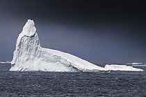 Iceberg and large fragments of drifting ice, here iceberg floating in front of the Antarctic Peninsula, climate melting global warming. Marguerite Bay, George VI Channel. Expedition below the South Polar Circle in Antarctica