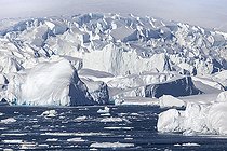 Iceberg and large fragments of drifting ice, here iceberg floating in front of the Antarctic Peninsula, climate melting global warming. Marguerite Bay, George VI Channel. Expedition below the South Polar Circle in Antarctica