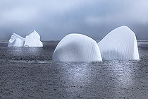 Iceberg and large fragments of drifting ice, here iceberg floating in front of the Antarctic Peninsula, climate melting global warming. Marguerite Bay, George VI Channel. Expedition below the South Polar Circle in Antarctica