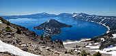 Panorama of Crater Lake with Wizard Island, Crater Lake National Park, Oregon, USA. Crater Lake is a caldera formed by the eruption of the Mazama volcano. Wizard Island lies to the west of the lake and is uninhabited. The lake is the deepest in the United States (592 m).
