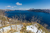 Lake Mashû caldera, with the central island, "Kamuishima", Island of the Gods. The Lake Mashû caldera is 6 kilometers long. Located at the foot of Mount Kamui in Akan-Mashû National Park, it was formed 4,000 years ago by the collapse of the Mashû volcano after its eruption. The lake is famous in Japan for the transparency of its waters.