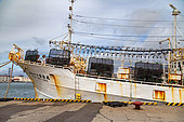 Fishing boat with lamparos, Hakodate harbor, Hokkaido, Japan. At night, fish and squid are attracted by the light of the lamps and gather near the boat. They are then caught with nets. This is an ancient fishing technique.
