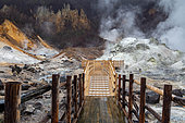Footbridge overlooking the Jigokudani geothermal site, Noboribetsu, Hokkaido Island, Japan. Noboribetsu, on the southeastern island of Hokkaido, is a spa town considered one of the most important in Japan. The town center is home to a geothermal zone known as "Jigokudani", the valley of hell.
