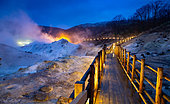 Illuminated pontoon overlooking the Jigokudani geothermal site, Noboribetsu, Hokkaido Island, Japan. The geothermal area known as "Jigokudani", the valley of hell, is also accessible by night. The illuminated pontoon forms a kind of garland across the apocalyptic landscape.