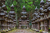 Ring pagoda (Gorinto) and lanterns (Tōrō) in the Okunoin necropolis, Japan's largest cemetery, Mount Koya, Osaka, Japan. Gorintō and Tōrō are funerary stone steles adorning Buddhist mausoleums and temples.