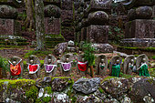 Statuettes (Jizô) in the Okunoi necropolis, Mount Koya, Osaka, Japan. The statuettes are the protectors of deceased children, dressed in bibs by local inhabitants, who also place offerings at their feet.