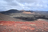 Bus tour in Timanfaya National Park, view of the Corazoncillo caldera, Montanas Los Miraderos, del Senalo and Pico Partido, Lanzarote Island, Canary Islands