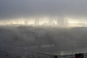 Overview of the city of Lyon in the mist with the rhone river in the foreground on the morning of a day when the air quality was indicated as degraded according to the atmo index indicating 64 AQI in Lyon, France. The air reached a high level of pollution, above the maximum 24-hour limit set by the WHO, and people were advised to avoid outdoor sports, have a coffee on a terrace and take their babies out.