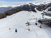 Aerial view made using a drone of an artificial snow landscape due to climate change at the La Plagne ski resort at the place called Le Fornelet arrival of the Montalbert gondola, on a sunny day in Aime la Plagne, France on March 6, 2025.