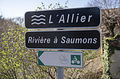 Salmon river and Via Allier cycle path sign below the name of the river Allier installed at the bridge at Saint-Arcons-d'Allier, France.