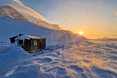 Cabin under the blizzard at sunset at Cape Brewster, Scoresby Strait, ScoresbySund, Greenland