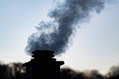Smoke from the chimney of a wood-heated house, France