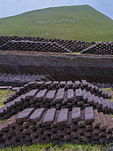 Traditional peat cutting, peat is still used as fuel for fireplaces, on the island Foula, part of Shetland Islands. Europe, Great Britain, Scotland, Northern Isles,summer