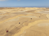 Quad bikes in the dunes of the Namib Desert in the vicinity of the coastal town of Swakopmund. Aerial view. Drone shot. Namibia.
