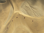 Quad bikes in the dunes of the Namib Desert in the vicinity of the coastal town of Swakopmund. Aerial view. Drone shot. Namibia.