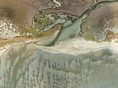 Marshes and streams at low tide in the Walvis Bay Lagoon. Aerial view. Drone shot. Namibia.