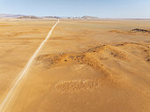 The C14 gravel road at the edge of the Namib Desert. Aerial view. Drone shot. Namibia.