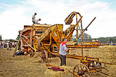 Old-fashioned harvest, threshing machine and straw baler on display at the harvest festival, village of Valenne, Sarthe, France