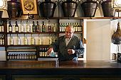 Barman pours a grappa in the Nardini bar. The bar has hardly changed since it opened in 1779. Bassano del Grappa, Veneto, Italy