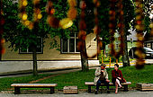 Trakai, Lithuania: people sitting on a bench in Trakai's former main square