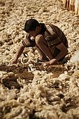 Worker laying out discarded wool to dry in the sun, the tanneries, Fes, Morocco
