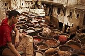 Young tannery worker looking over the tanneries, Fes, Morocco