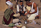 A Brahman practicing a funeral rite to a pilgrim from India's south.