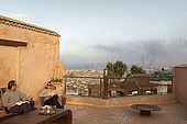 Roof terrace and view towards potteries (smoke), Riad Larrousa, traditional Moroccan riad, Fes, Morocco. Property released.