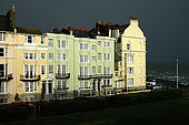 Street of traditional Regency-style buildings - all offering bed and breakfast - on the coast at Brighton during a storm
