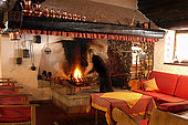 Lounge with large open log fire, Maso Doss, Pinzolo, Trentino, Italy. Tel 0465 502758