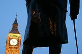 England, London, Westminster. Big Ben framed by a statue of Winston Churchill by Ivor Roberts-Jones
