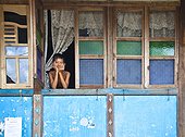 A Boy Looks Out The Window Of His House; Prabumulih Timur Sumatera Selatan Indonesia