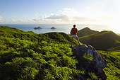 Hawaii, Oahu, Lanikai, Woman hiker admiring view of Mokulua Islands.