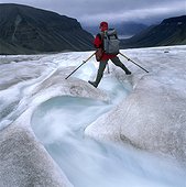 Mountaineer standing over a brook