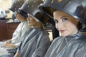 Women sitting under hair dryers